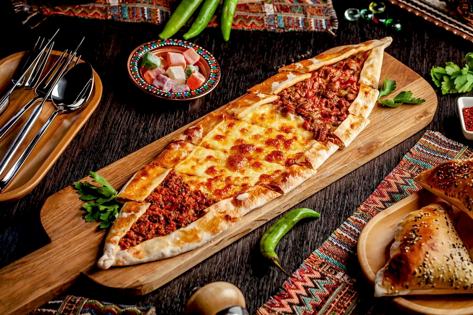 Traditional Turkish cuisine. Turkish pizza Pita with a different stuffing, meat, cheese, slices of veal. Turk Pidesi or Sucuk Pide. Serving dishes in the restaurant. Copy space