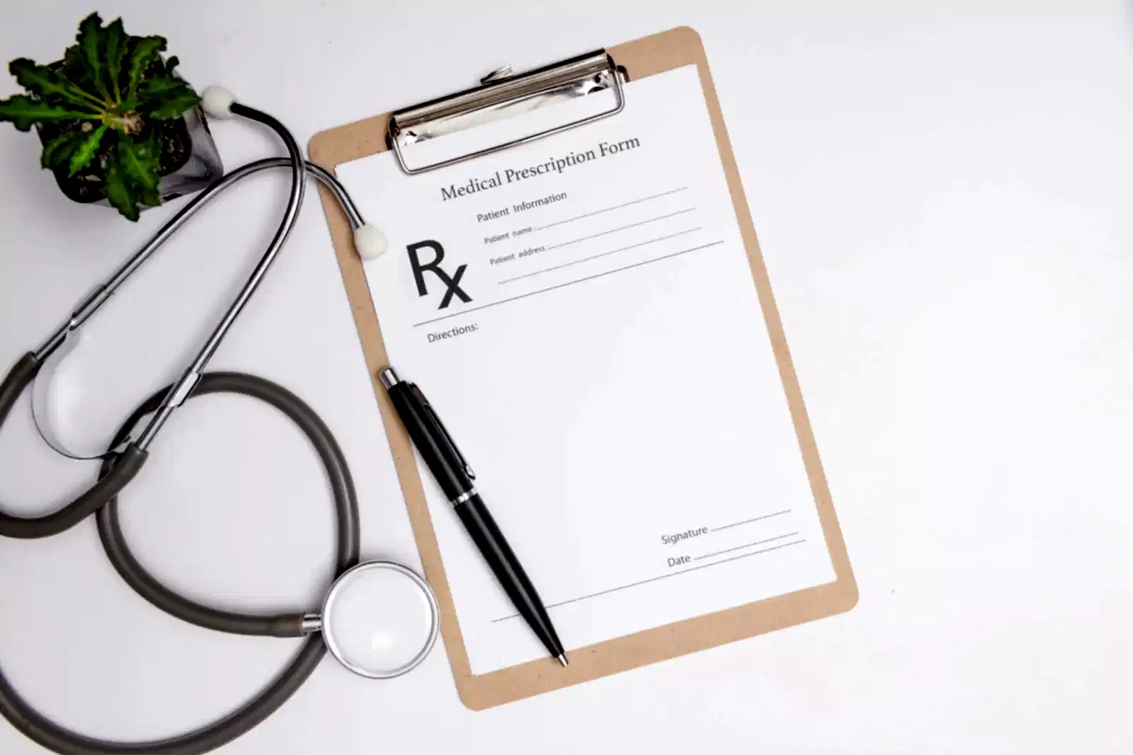 Stethoscope, a pen and a blank prescription pad.  Medicine or pharmacy concept. Empty medical form ready to be used. Modern medical Information technology.